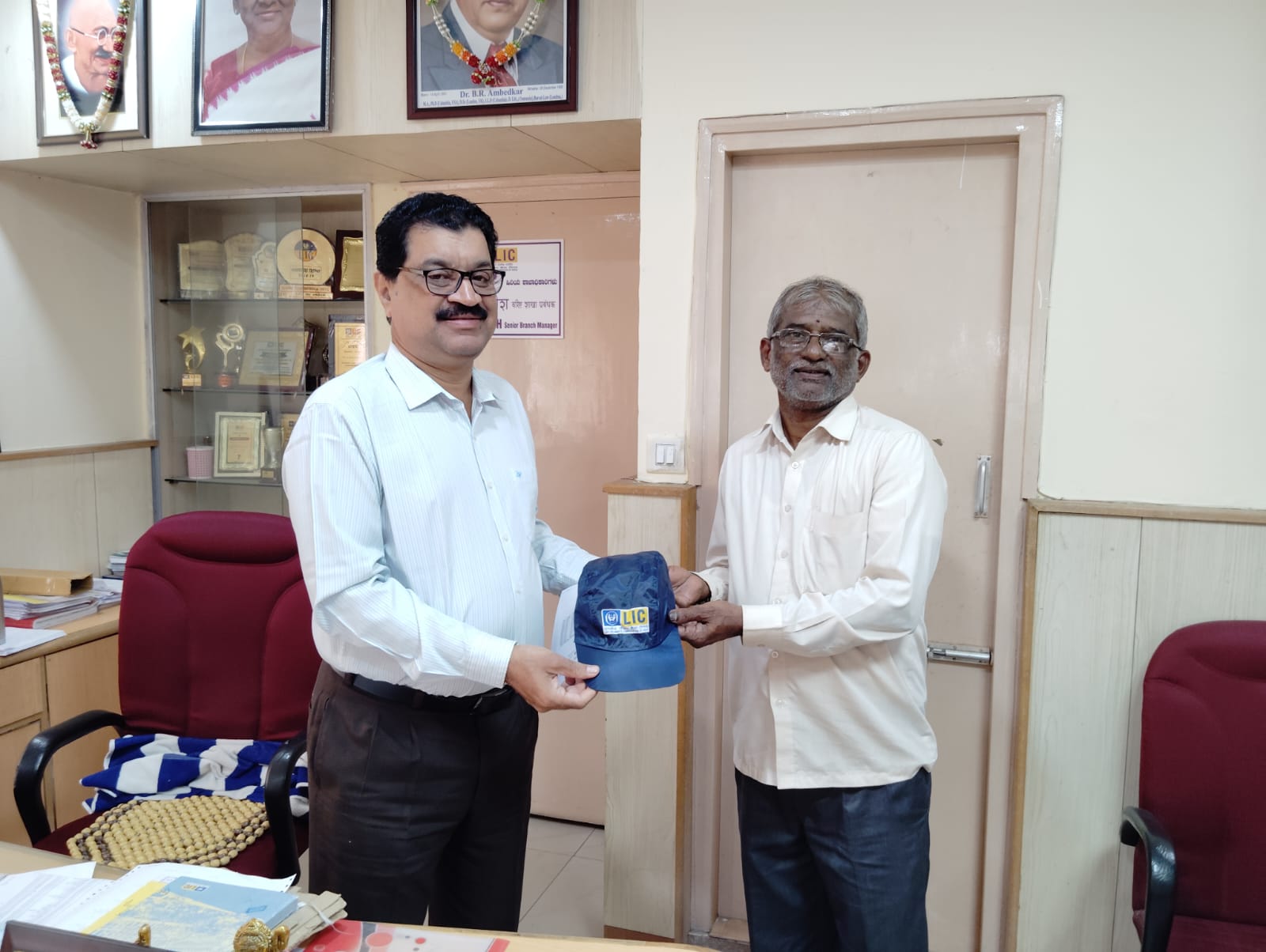Agent Mahabala B M with 36 years experience honored by Senior Branch Manager